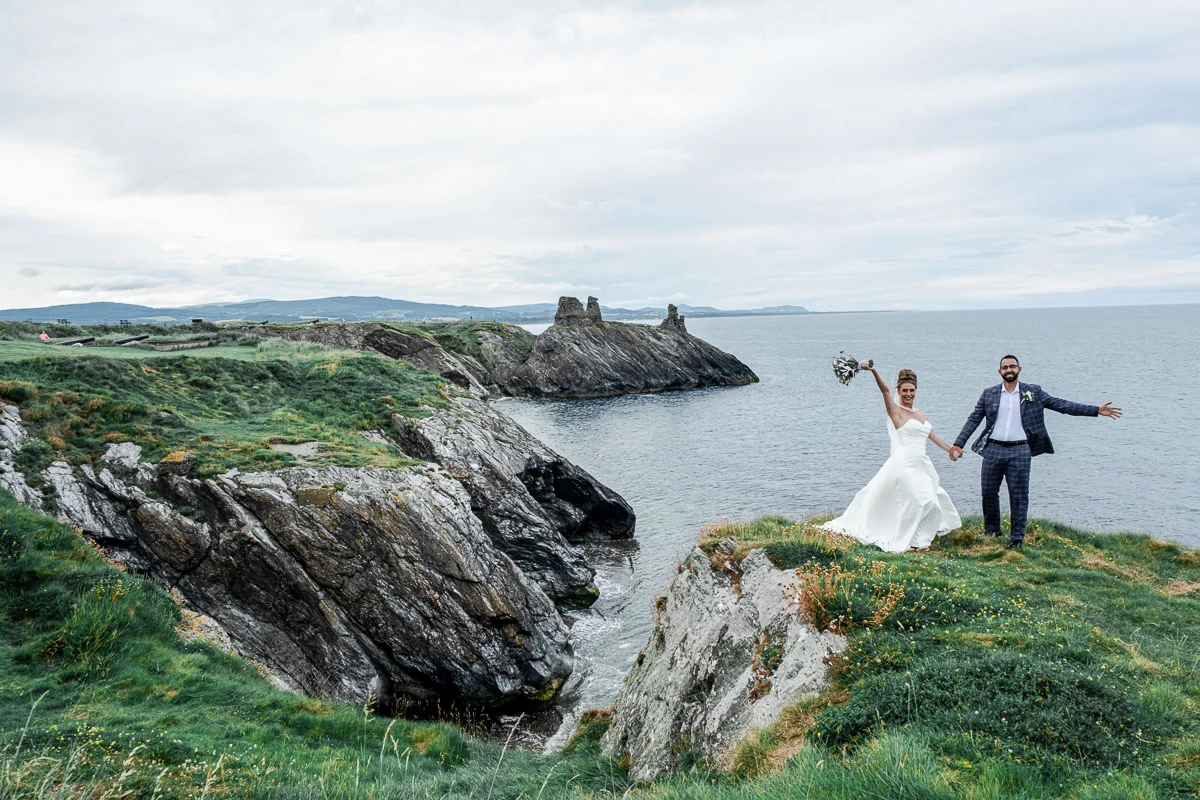 Bride and groom celebrating Ireland wedding at Black Castle coast