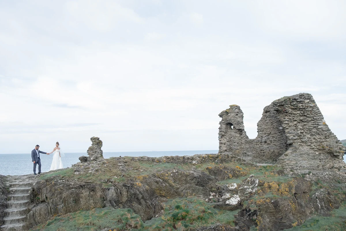 Ireland wedding couple at Black Castle ruins overlooking the sea