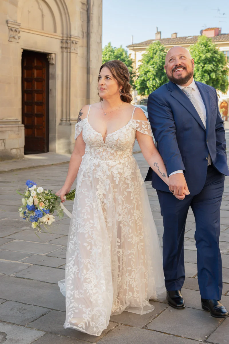 elopment at Fiesole, Tuscany-02 Bride and groom smiling after their elopement ceremony in Fiesole, Tuscany — she holds a wildflower bouquet of blue and white blooms