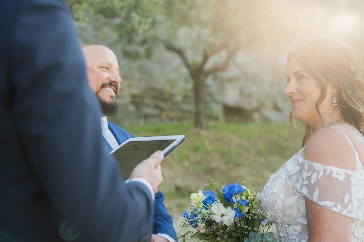 elopment at Fiesole, Tuscany-10 Bride and groom exchanging glances and smiling during their outdoor elopement ceremony in Fiesole, bathed in warm Tuscan sunlight