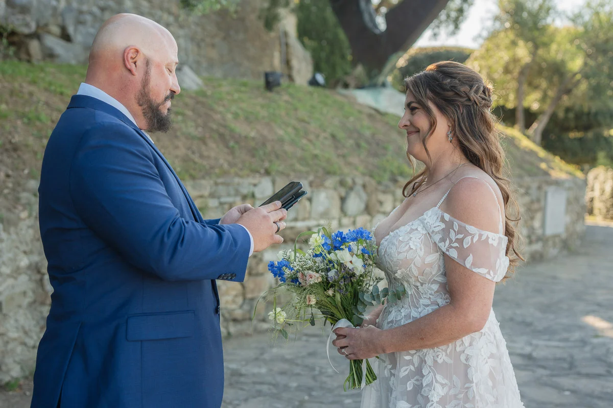elopment at Fiesole, Tuscany-11 Groom reading personal vows from his phone to his bride during their intimate elopement ceremony in Fiesole, Tuscany