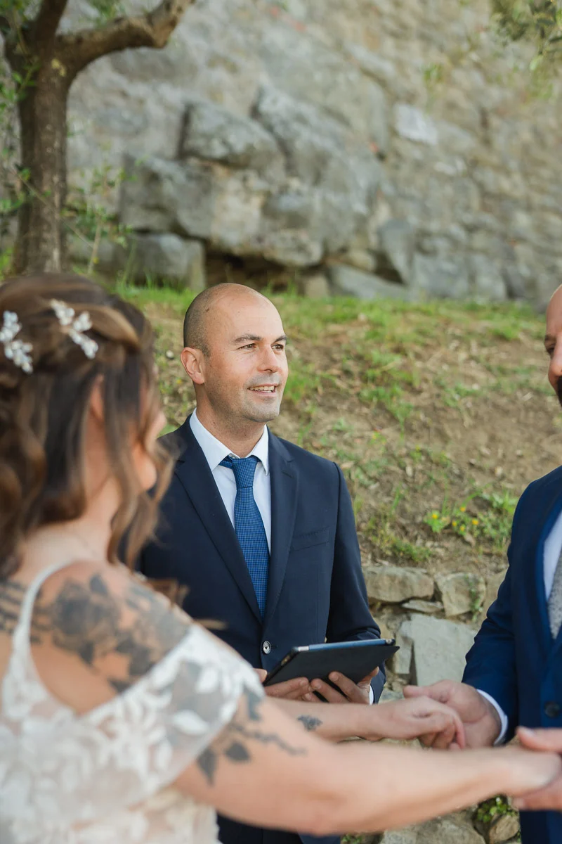 elopment at Fiesole, Tuscany-17 Elopement celebrant officiating an intimate outdoor wedding ceremony in Fiesole, Tuscany, with the couple holding hands before him