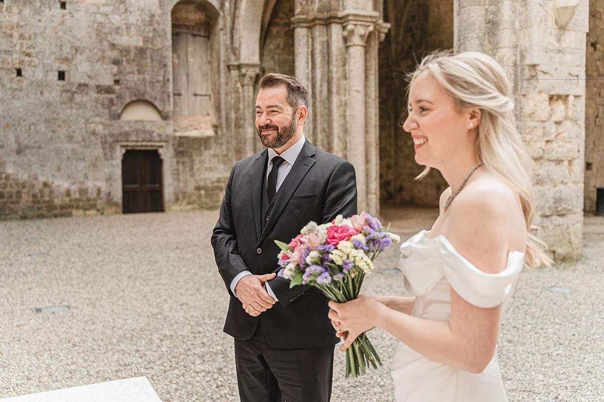 elopment wedding in Tuscany-San Galgano-09 Couple sharing their first look at San Galgano Abbey ruins, Tuscany