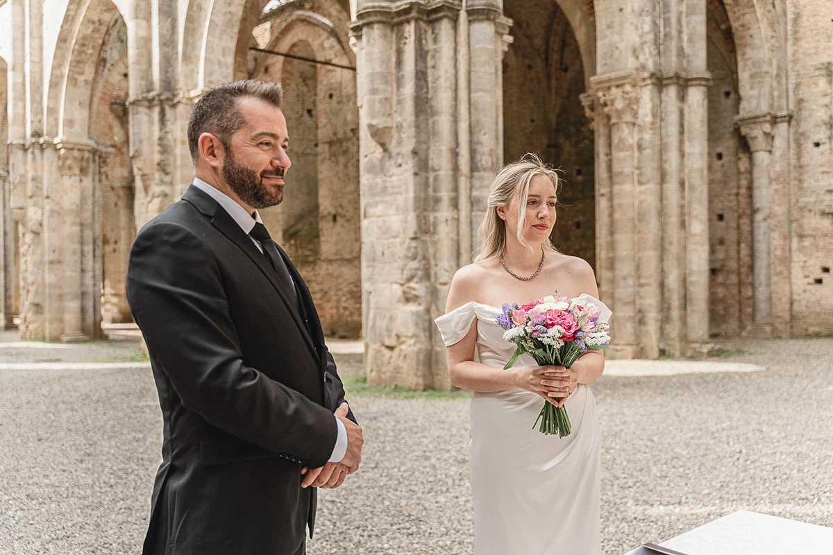 elopment wedding in Tuscany-San Galgano-13 Bride and groom standing together at San Galgano Abbey before their elopement ceremony