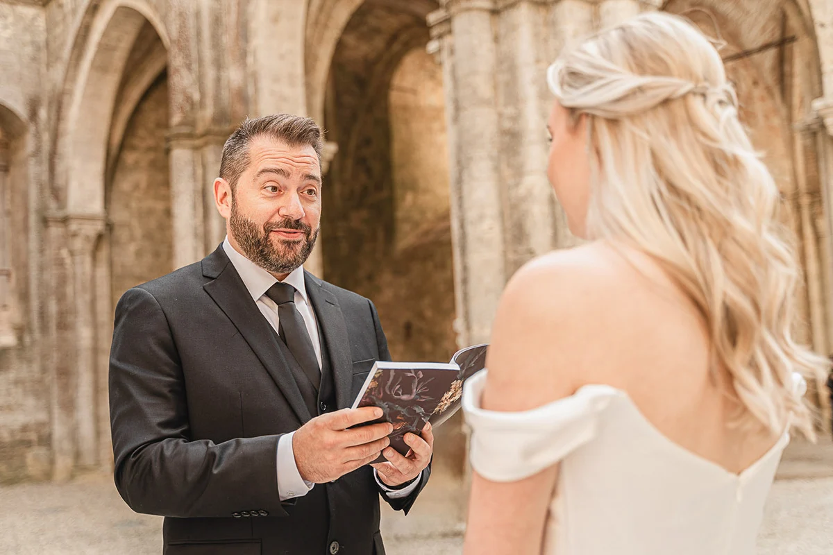 elopment wedding in Tuscany-San Galgano-14 Groom reading his wedding vows to his bride at San Galgano Abbey, Tuscany