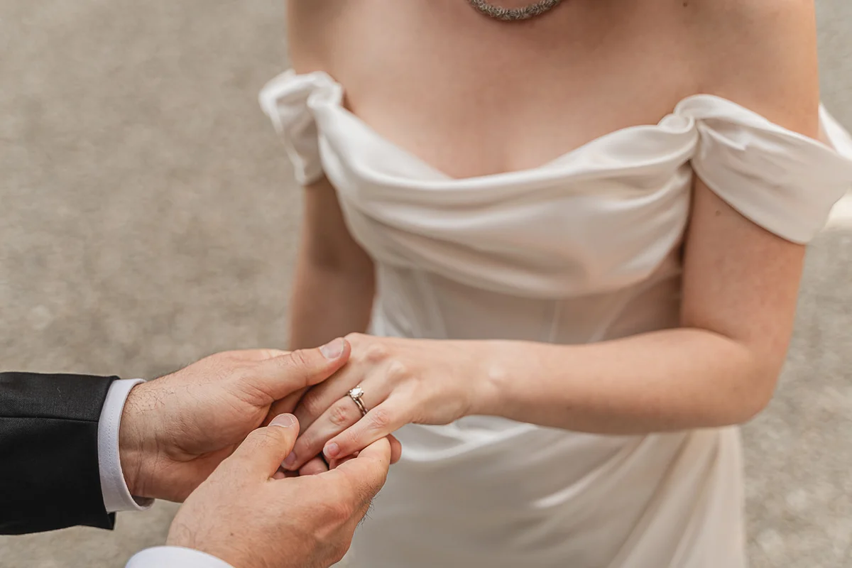 elopment wedding in Tuscany-San Galgano-20 Groom placing the wedding ring on bride's finger at San Galgano Abbey