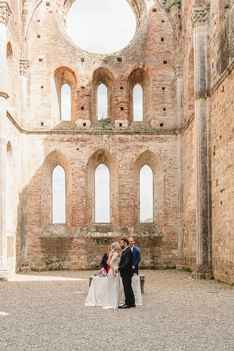 elopment wedding in Tuscany-San Galgano-22 Newlyweds standing together inside the nave of San Galgano Abbey after the ceremony