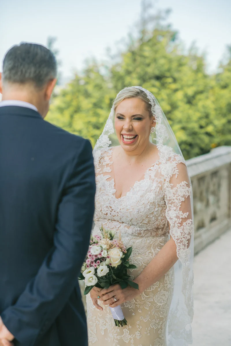 Jennifer smiling during her wedding ceremony at Biester Palace, Sintra