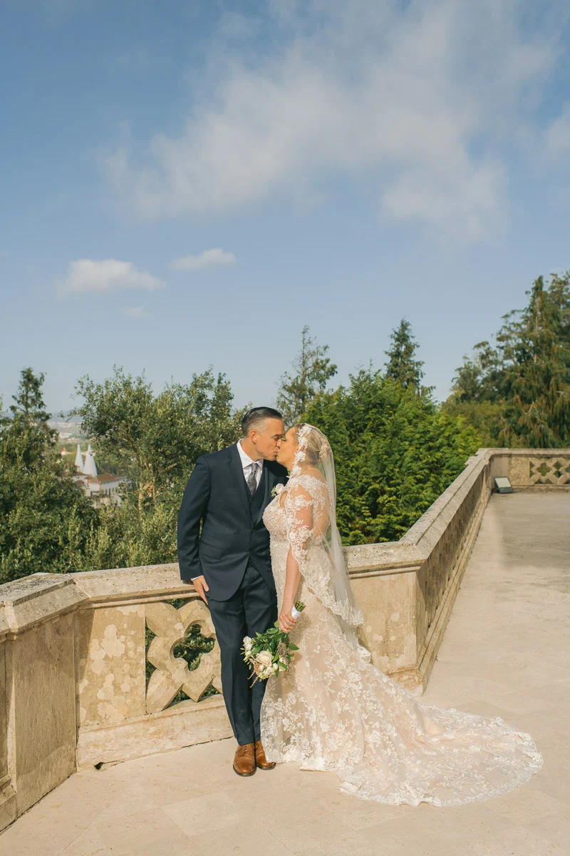 Ethan and Jennifer kissing on the stone terrace of Biester Palace, Sintra
